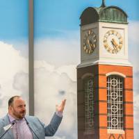 New University Carillonneur Jon Lehrer speaking at podium